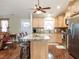 Open kitchen with granite island and stainless steel appliances, seamlessly connected to the living space at 30 Imperial Dr, Clayton, NC 27527