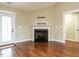 Bright living room featuring wood floors, a fireplace, and a door to the backyard at 30 Imperial Dr, Clayton, NC 27527