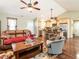 Bright, open living room connecting to a modern kitchen with wood floors and a fireplace at 30 Imperial Dr, Clayton, NC 27527