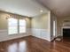 Bright sunroom with wainscoting, large windows, and hardwood floors leads to the living room at 30 Imperial Dr, Clayton, NC 27527