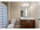 A bright bathroom with a single sink vanity and a shower tub with a blue striped curtain at 3003 Weston Green Loop, Cary, NC 27513