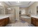 A luxurious primary bath features a garden tub, a tiled shower, and double vanities at 3003 Weston Green Loop, Cary, NC 27513