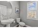 Half bathroom with pedestal sink, toilet, and window at 3003 Weston Green Loop, Cary, NC 27513