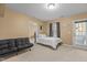 A large secondary bedroom has carpet, a futon, a full-size bed and a door to the outside at 3003 Weston Green Loop, Cary, NC 27513