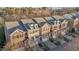 Exterior view of townhomes with brick facades, garages, and well-maintained landscaping at 3003 Weston Green Loop, Cary, NC 27513