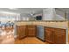 Kitchen with stainless steel dishwasher and light wood cabinets and granite countertop at 3003 Weston Green Loop, Cary, NC 27513