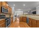 View of kitchen with stainless steel appliances, granite countertops, and wood floors at 3003 Weston Green Loop, Cary, NC 27513