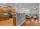Open kitchen features stainless steel appliances, granite countertops and wood cabinets at 3003 Weston Green Loop, Cary, NC 27513
