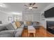 Spacious living room with a fireplace, ceiling fan, and comfortable seating at 3003 Weston Green Loop, Cary, NC 27513