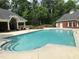 Community pool with clear water, surrounded by lush landscaping and a covered pavilion at 3003 Weston Green Loop, Cary, NC 27513