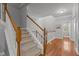 Staircase with carpeted steps and wood railings with hardwood flooring at 3003 Weston Green Loop, Cary, NC 27513