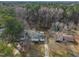 An aerial view of a home nestled among mature trees in a quiet neighborhood near a wooded area at 305 November St, Garner, NC 27529