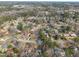 A captivating aerial view reveals a community of homes surrounded by a dense forest at 305 November St, Garner, NC 27529