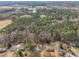 Sweeping aerial shot reveals homes nestled near a sprawling forest and serene body of water at 305 November St, Garner, NC 27529