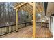 Wooden back deck with black railings, and wooden overhead pergola with views of the yard at 305 November St, Garner, NC 27529