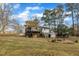 Back of home featuring a wooden deck, fire pit and shed in the backyard at 305 November St, Garner, NC 27529