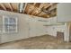Unfinished basement space with utility access, wood floors, and a mudroom sign above the door at 305 November St, Garner, NC 27529