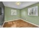 Bedroom with two windows providing natural light, hardwood floors, and neutral walls at 305 November St, Garner, NC 27529