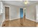 Spacious bedroom with hardwood floors, ceiling fan, and access to an ensuite bathroom at 305 November St, Garner, NC 27529