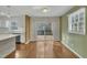 Bright living room with hardwood floors and a seamless transition to the modern kitchen and outdoor deck at 305 November St, Garner, NC 27529