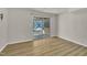 Room with wood floor, white walls and sliding glass door leading to outdoor patio at 305 November St, Garner, NC 27529