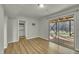 Room with wood floor, white walls, a storage closet and sliding glass doors to the backyard at 305 November St, Garner, NC 27529
