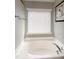 Close-up of a bright bathroom featuring a relaxing soaking tub beneath a window at 309 Mainline Sta, Morrisville, NC 27560