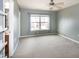 Spacious bedroom with neutral carpet, ceiling fan, and a large window with exterior view at 309 Mainline Sta, Morrisville, NC 27560