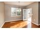 Dining area featuring hardwood floors, hanging chandelier, window, and access to the backyard at 309 Mainline Sta, Morrisville, NC 27560
