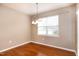 Dining room featuring hardwood floors, a hanging light fixture, and a large window at 309 Mainline Sta, Morrisville, NC 27560