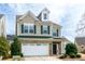 Two-story home with a two car garage, neutral siding and green shutters at 309 Mainline Sta, Morrisville, NC 27560