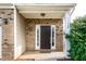 Charming front entrance with a brick facade and decorative welcome mat at 309 Mainline Sta, Morrisville, NC 27560