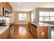 Bright kitchen featuring stainless steel appliances, granite counters, and wood cabinets at 309 Mainline Sta, Morrisville, NC 27560