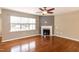 Inviting living room showcasing a cozy fireplace, large window, and a modern ceiling fan at 309 Mainline Sta, Morrisville, NC 27560