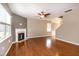 Bright living room features a fireplace, hardwood floors, ceiling fan, and abundant natural light at 309 Mainline Sta, Morrisville, NC 27560