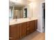 Main bathroom featuring a double sink vanity with wooden cabinets and a large mirror at 309 Mainline Sta, Morrisville, NC 27560