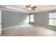 Bright main bedroom with a ceiling fan and two windows providing ample natural light at 309 Mainline Sta, Morrisville, NC 27560