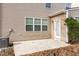 Back patio with neutral siding, white trim and sliding glass door at 309 Mainline Sta, Morrisville, NC 27560