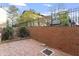 Brick patio with mature trees and a privacy fence creating a serene outdoor retreat at 318 Mccauley St # 2, Chapel Hill, NC 27516