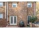 Brick home with brick patio, double doors, and lush landscaping at 318 Mccauley St # 2, Chapel Hill, NC 27516