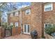 Brick patio with mature trees and a privacy fence creating a serene outdoor retreat at 318 Mccauley St # 2, Chapel Hill, NC 27516
