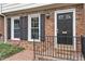 Welcoming front entrance of a townhouse with classic brickwork and a secure CPI security system at 318 Mccauley St # 2, Chapel Hill, NC 27516