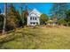 The back yard has a lush lawn and ample patio space at 319 W Margaret Ln, Hillsborough, NC 27278