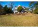 View of backyard and second story porch of home with mature trees and blue sky at 319 W Margaret Ln, Hillsborough, NC 27278