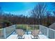 Inviting balcony with two chairs overlooking a lush green backyard at 319 W Margaret Ln, Hillsborough, NC 27278