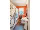Unique bathroom with colorful walls, pedestal sink, and patterned shower curtain at 319 W Margaret Ln, Hillsborough, NC 27278