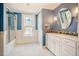 Bright renovated bathroom with blue walls and a shower/tub combo at 319 W Margaret Ln, Hillsborough, NC 27278
