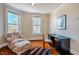 Bright bedroom features two windows, wood floors, and a black writing desk at 319 W Margaret Ln, Hillsborough, NC 27278
