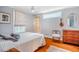 Sunlit bedroom with hardwood floors, ceiling fan, and comfy bedding at 319 W Margaret Ln, Hillsborough, NC 27278