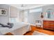 Sunlit bedroom with hardwood floors, ceiling fan, and comfy bedding at 319 W Margaret Ln, Hillsborough, NC 27278